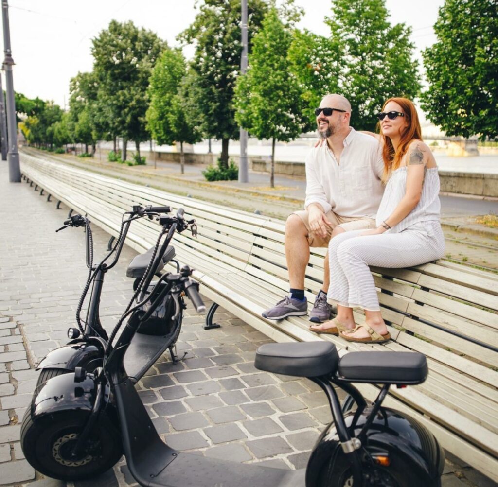 Electric scooters in Budapest - a couple stopping to enjoy the view